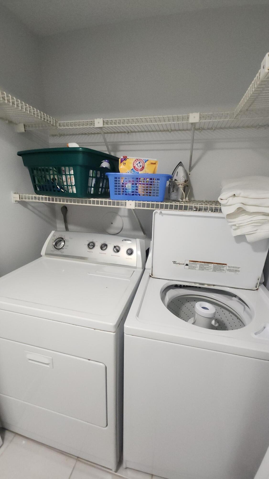 171 Deer Creek Boulevard, Unit 701 Deerfield Beach, FL 33442 - Photo 18 of 23 a utility room with dryer and washer