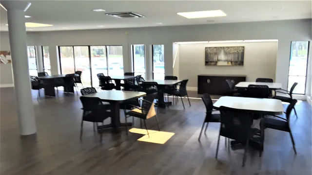 a room with table chairs and window