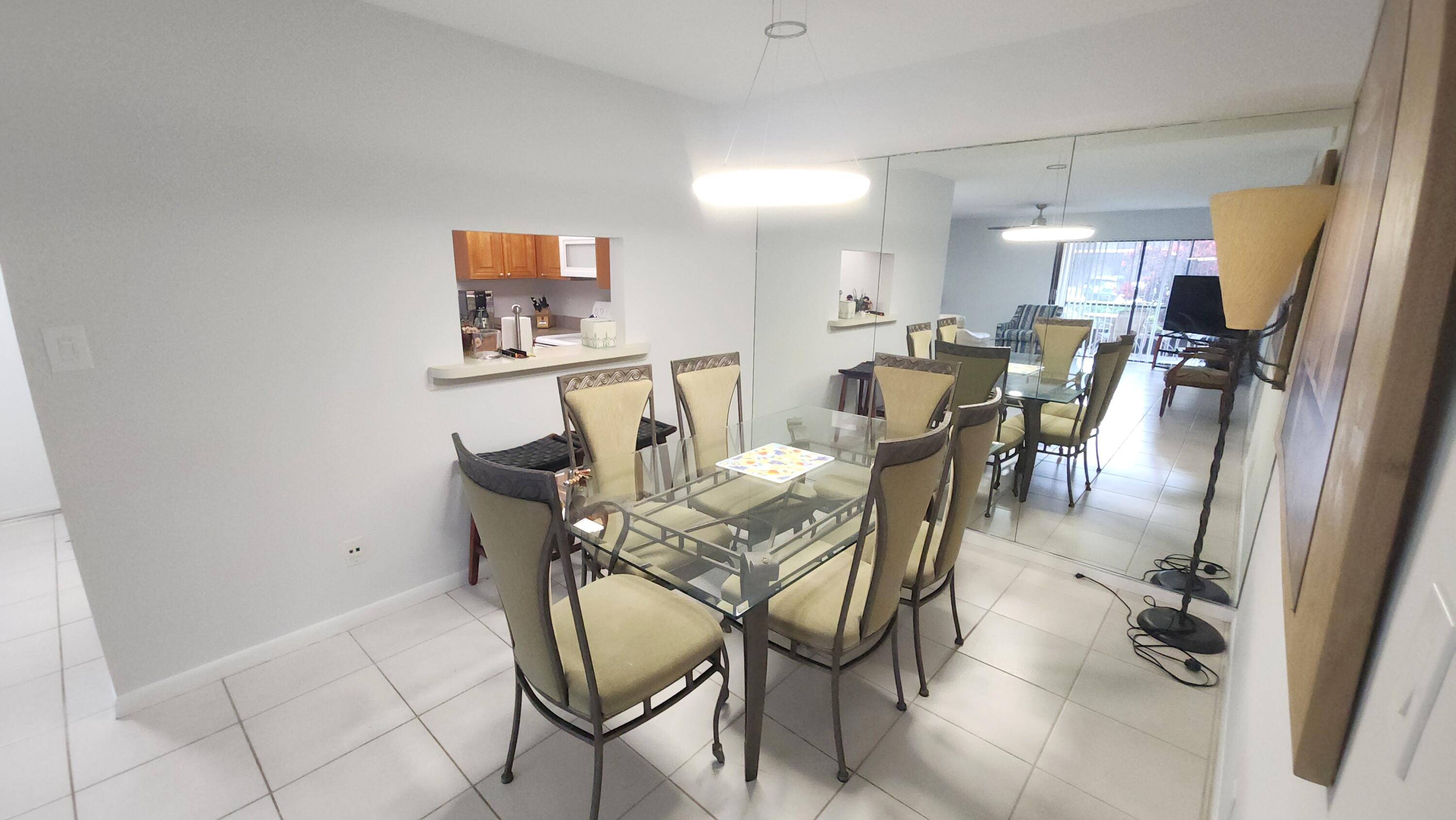 171 Deer Creek Boulevard, Unit 701 Deerfield Beach, FL 33442 - Photo 6 of 23 a view of a dining room with furniture