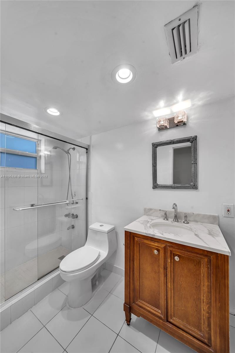 247 Bird Road Coral Gables, FL 33134 - Photo 15 of 22 a bathroom with a sink toilet and shower