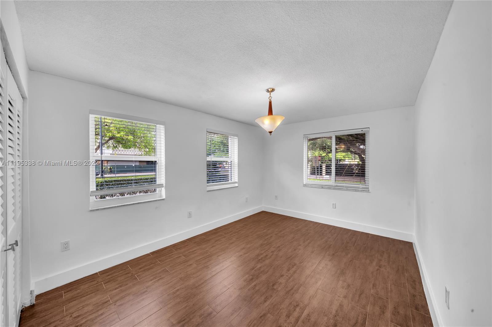 247 Bird Road Coral Gables, FL 33134 - Photo 16 of 22 wooden floor in an empty room with a window
