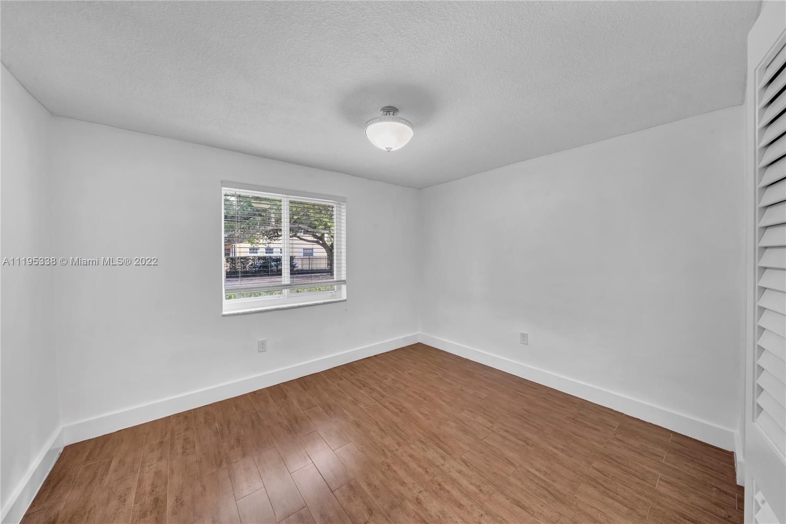 247 Bird Road Coral Gables, FL 33134 - Photo 18 of 22 wooden floor in an empty room with a window