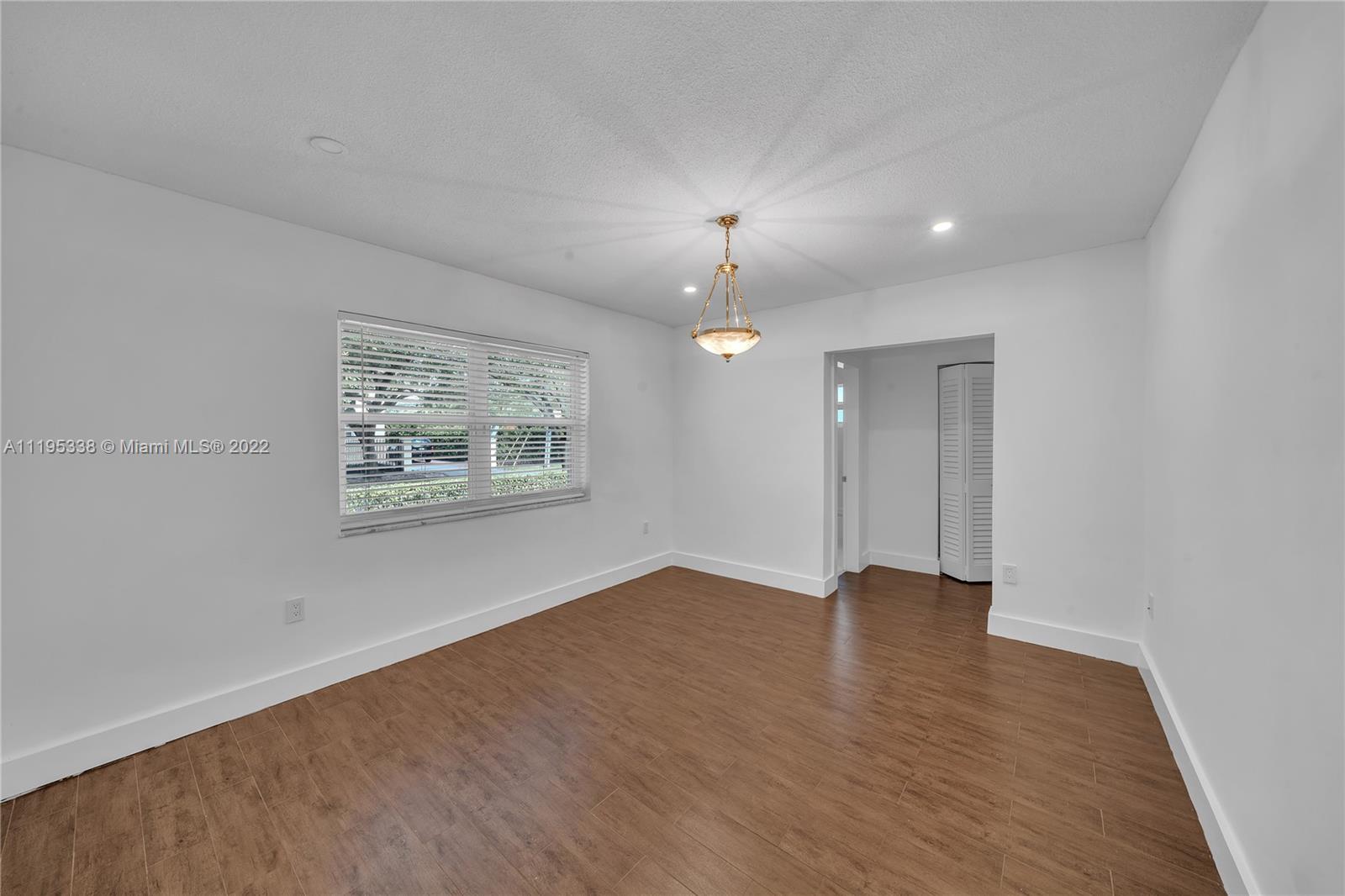 247 Bird Road Coral Gables, FL 33134 - Photo 19 of 22 wooden floor in an empty room with a window