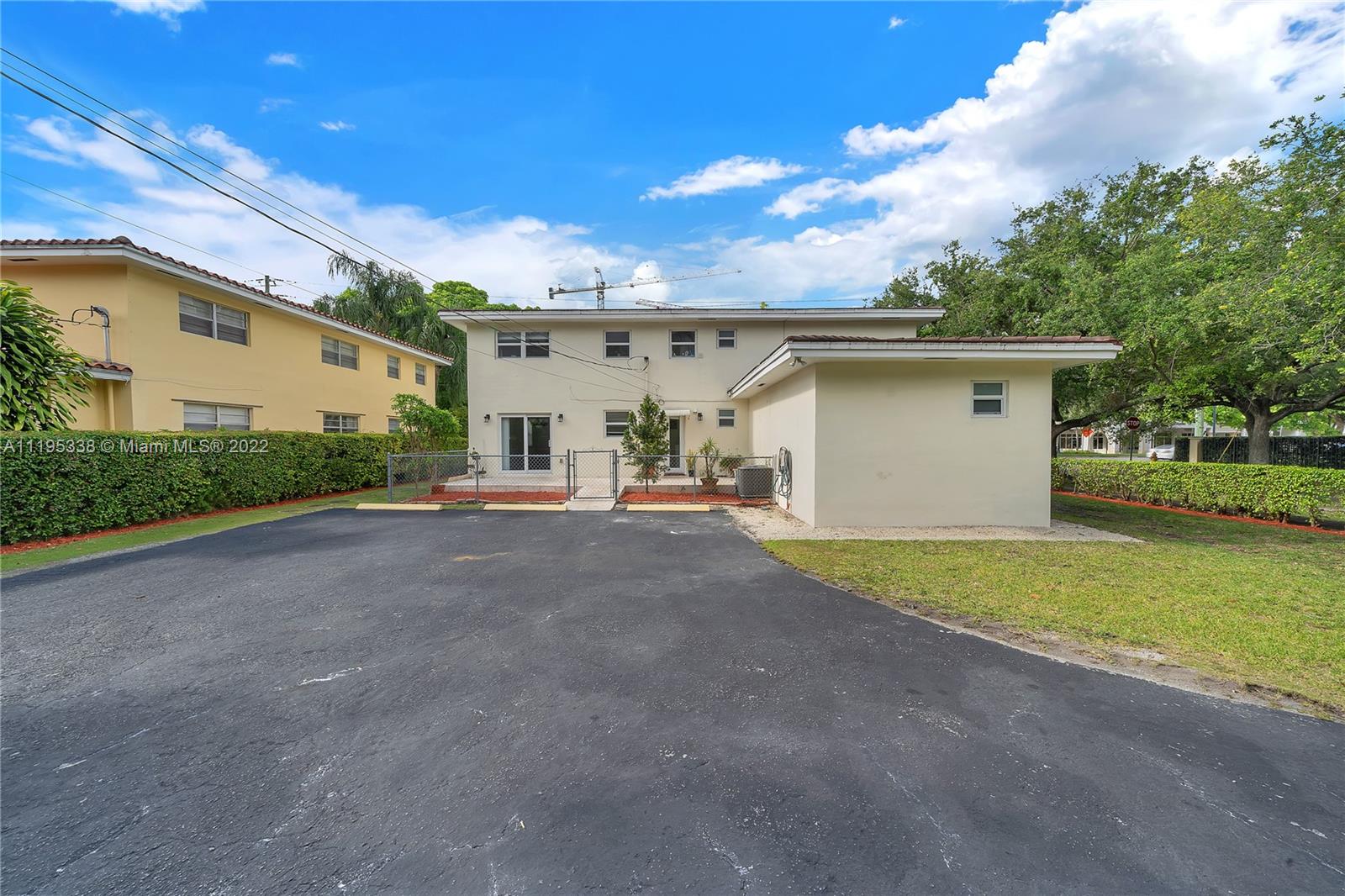 247 Bird Road Coral Gables, FL 33134 - Photo 6 of 22 a view of a house with backyard and trees