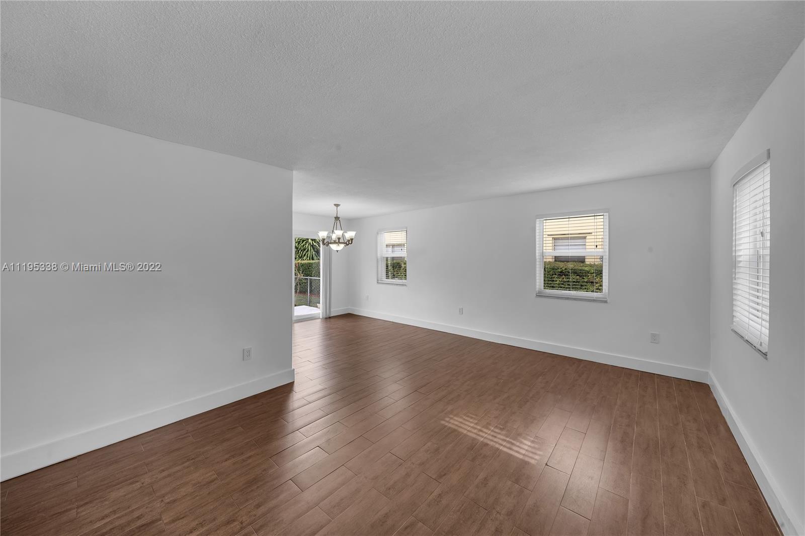247 Bird Road Coral Gables, FL 33134 - Photo 8 of 22 an empty room with wooden floor and windows
