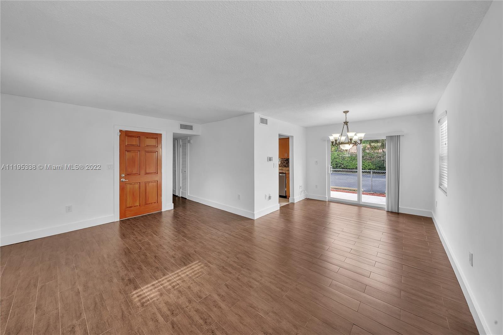 247 Bird Road Coral Gables, FL 33134 - Photo 9 of 22 a view of an empty room with wooden floor and a window