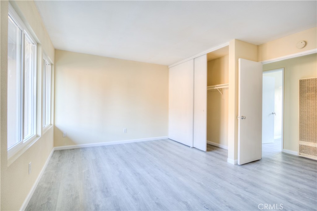 154 South Linda Way, Unit C Upland, CA 91786 - Photo 13 of 21 an empty room with wooden floor and windows