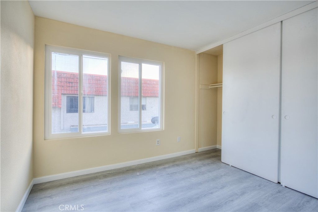 154 South Linda Way, Unit C Upland, CA 91786 - Photo 14 of 21 an empty room with wooden floor and windows