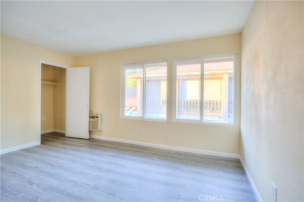 154 South Linda Way, Unit C Upland, CA 91786 - Photo 15 of 21 an empty room with wooden floor and windows