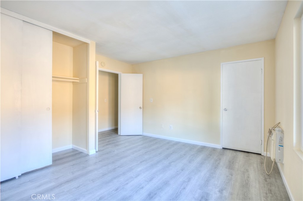 154 South Linda Way, Unit C Upland, CA 91786 - Photo 16 of 21 a view of an empty room with wooden floor and a window