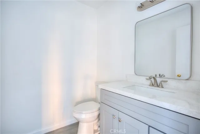 a bathroom with a sink a toilet and mirror