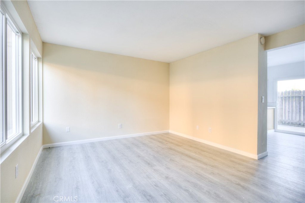 154 South Linda Way, Unit C Upland, CA 91786 - Photo 7 of 21 a view of an empty room with wooden floor and a window