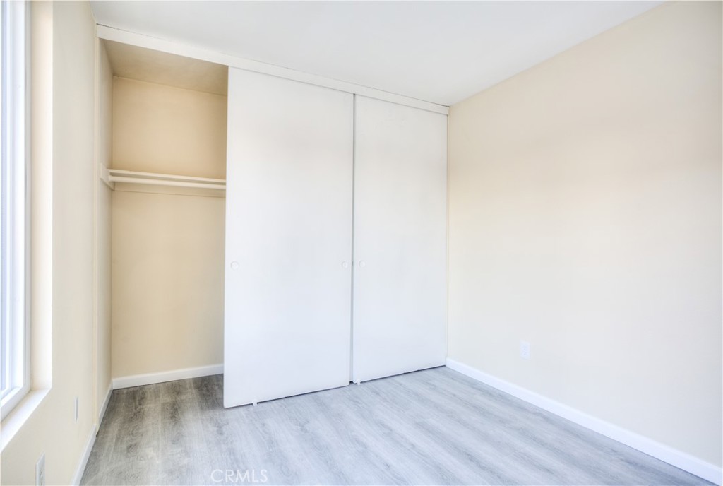154 South Linda Way, Unit C Upland, CA 91786 - Photo 8 of 21 a view of an empty room with wooden floor and a window