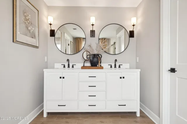 a bathroom with 2 sink and a mirror