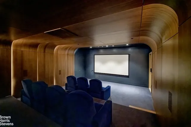 a living room with furniture and a ceiling fan