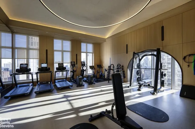 a view of a livingroom with furniture and gym equipment