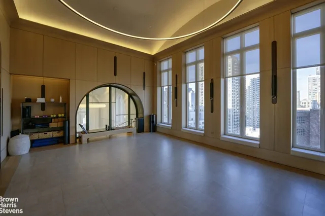 a view of an empty room with glass door and a window
