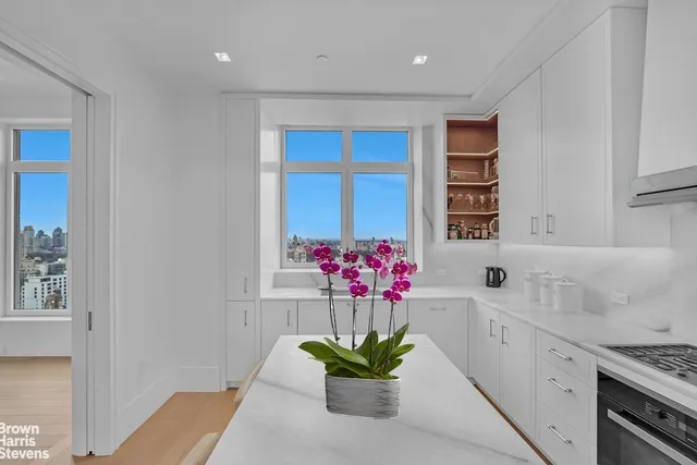 a kitchen with stainless steel appliances kitchen island granite countertop a sink and cabinets