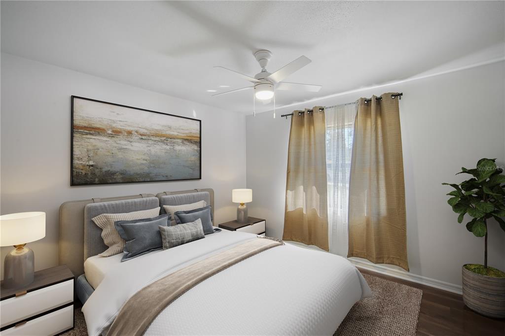 109 Holly Tree Lane Brandon, FL 33511 - Photo 20 of 31 a bedroom with a large bed and a chandelier