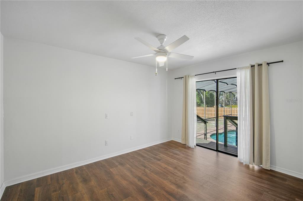 109 Holly Tree Lane Brandon, FL 33511 - Photo 25 of 31 an empty room with wooden floor and windows