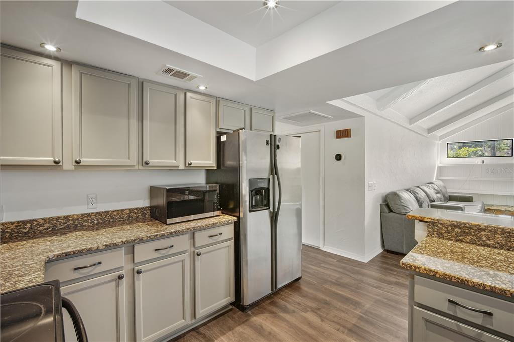 109 Holly Tree Lane Brandon, FL 33511 - Photo 9 of 31 a kitchen with stainless steel appliances granite countertop a refrigerator and a stove top oven