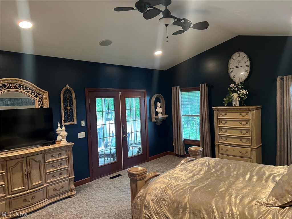 1457 Terrace Road Northwest New Philadelphia, OH 44663 - Photo 17 of 33 Carpeted bedroom featuring multiple windows, french doors, access to outside, lofted ceiling, and ceiling fan
