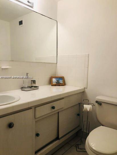 100 Lincoln Road, Unit 541 Miami Beach, FL 33139 - Photo 6 of 9 a bathroom with a sink a toilet and mirror