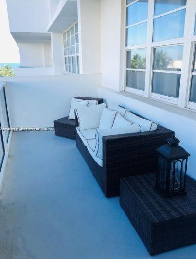 100 Lincoln Road, Unit 541 Miami Beach, FL 33139 - Photo 9 of 9 a living room with furniture and a fireplace