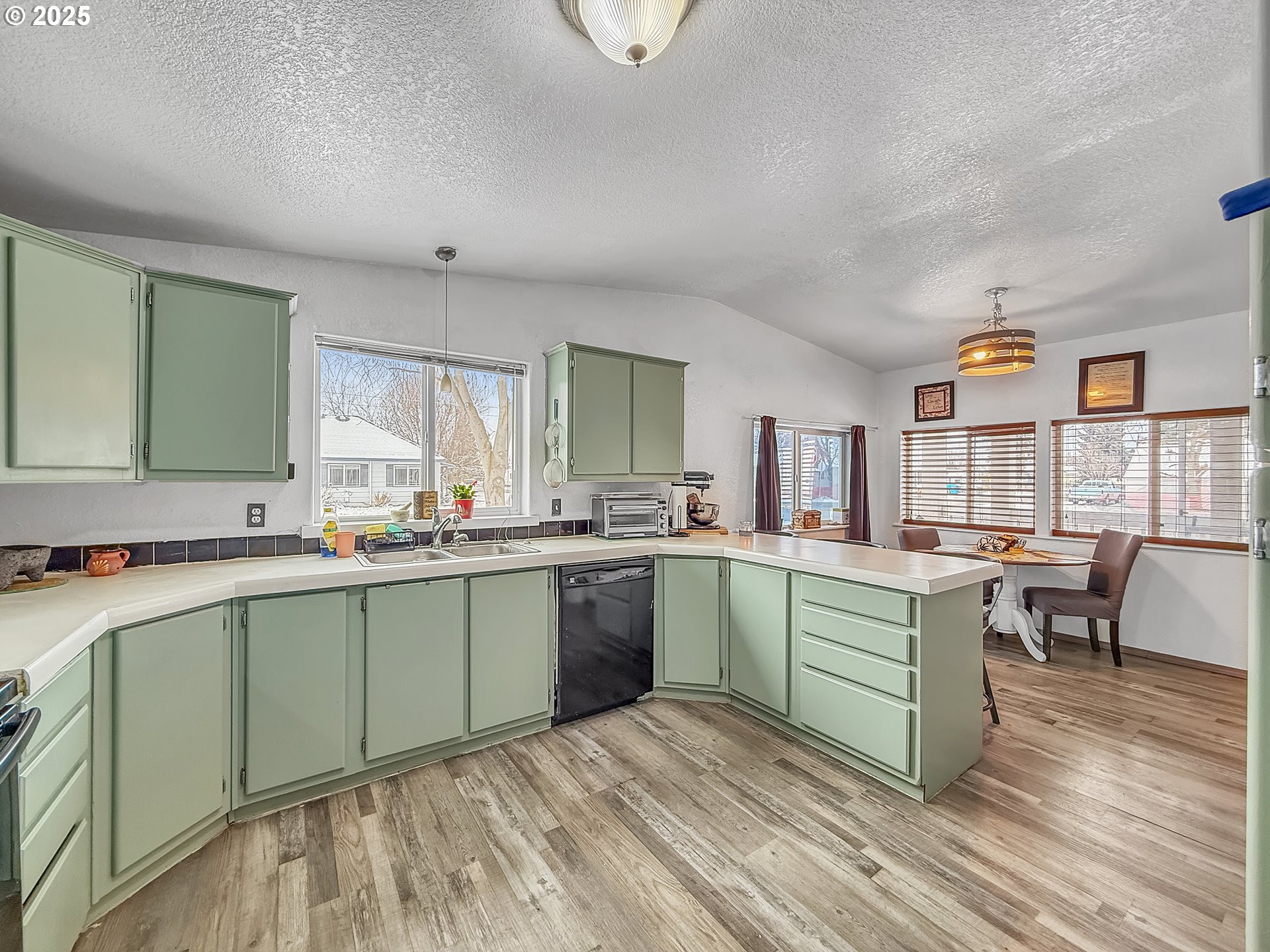2084 18th Street Baker City, OR 97814 - Photo 13 of 40 a kitchen with a sink cabinets and wooden floor
