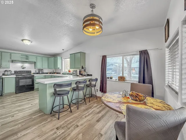 a dining room with wooden floor and a clock
