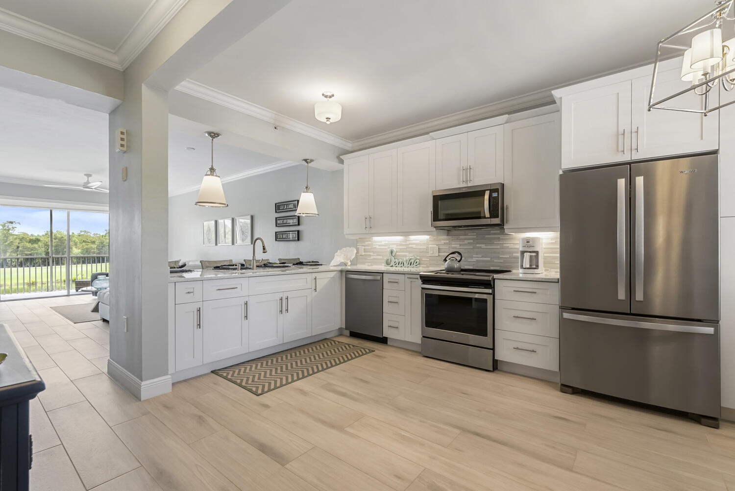 3780 Sawgrass Way, Unit 3325 Naples, FL 34112 - Photo 1 of 49 a kitchen with a refrigerator stove and sink