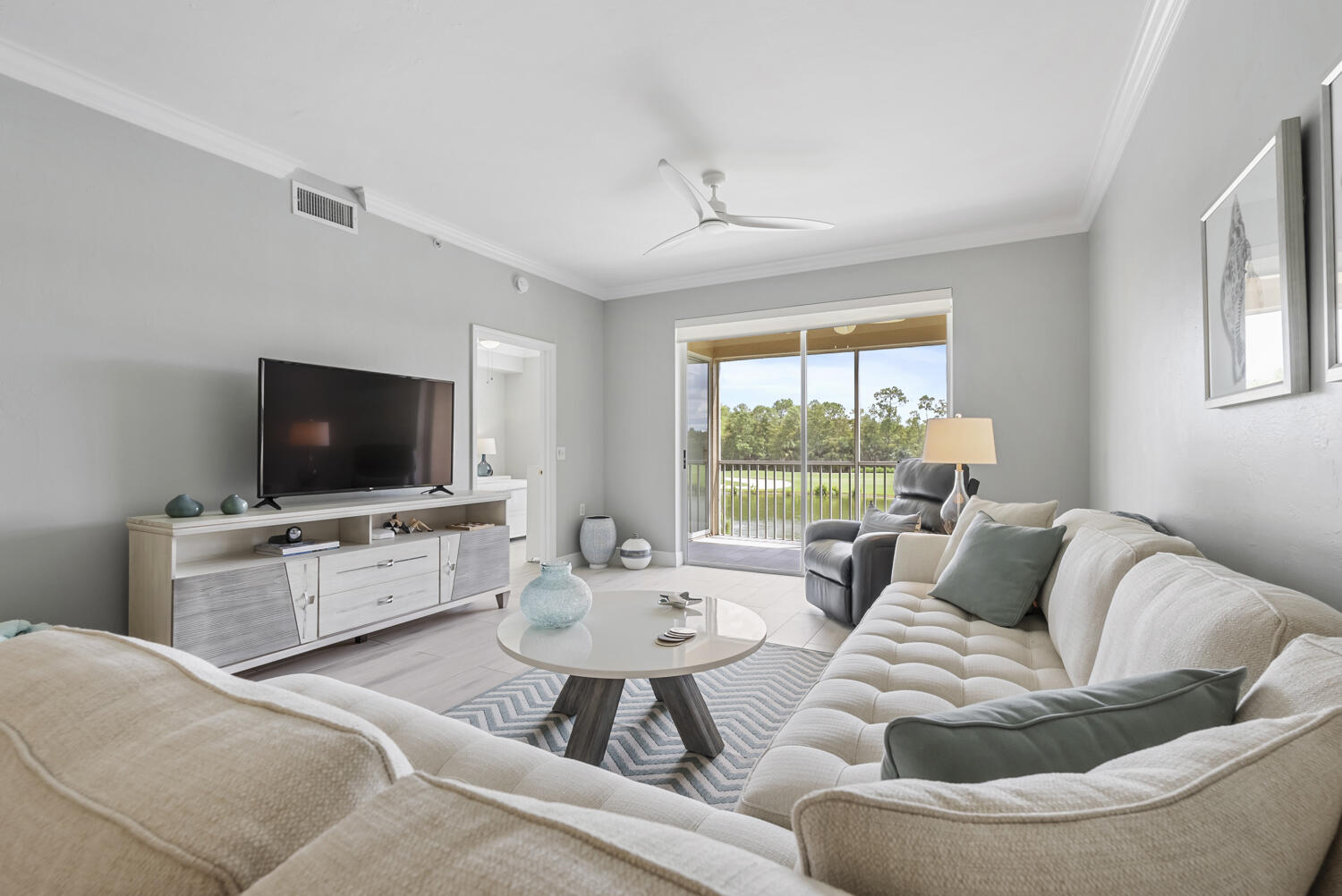 3780 Sawgrass Way, Unit 3325 Naples, FL 34112 - Photo 13 of 49 a living room with furniture and a flat screen tv