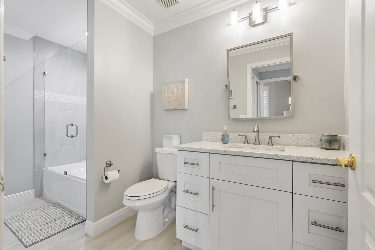 3780 Sawgrass Way, Unit 3325 Naples, FL 34112 - Photo 24 of 49 a bathroom with a toilet a sink a mirror and a shower