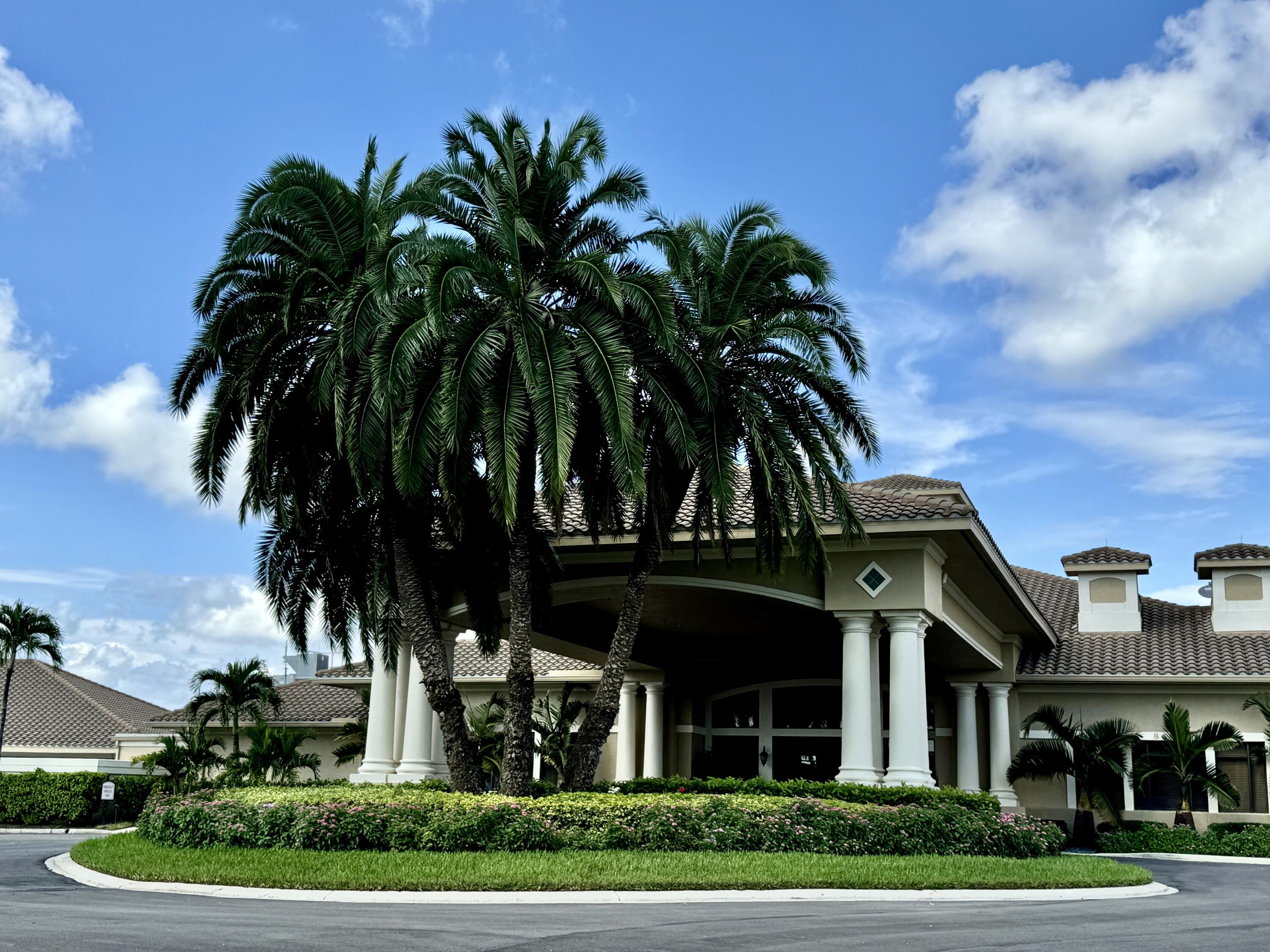 3780 Sawgrass Way, Unit 3325 Naples, FL 34112 - Photo 33 of 49 a view of a house with a yard and potted plants