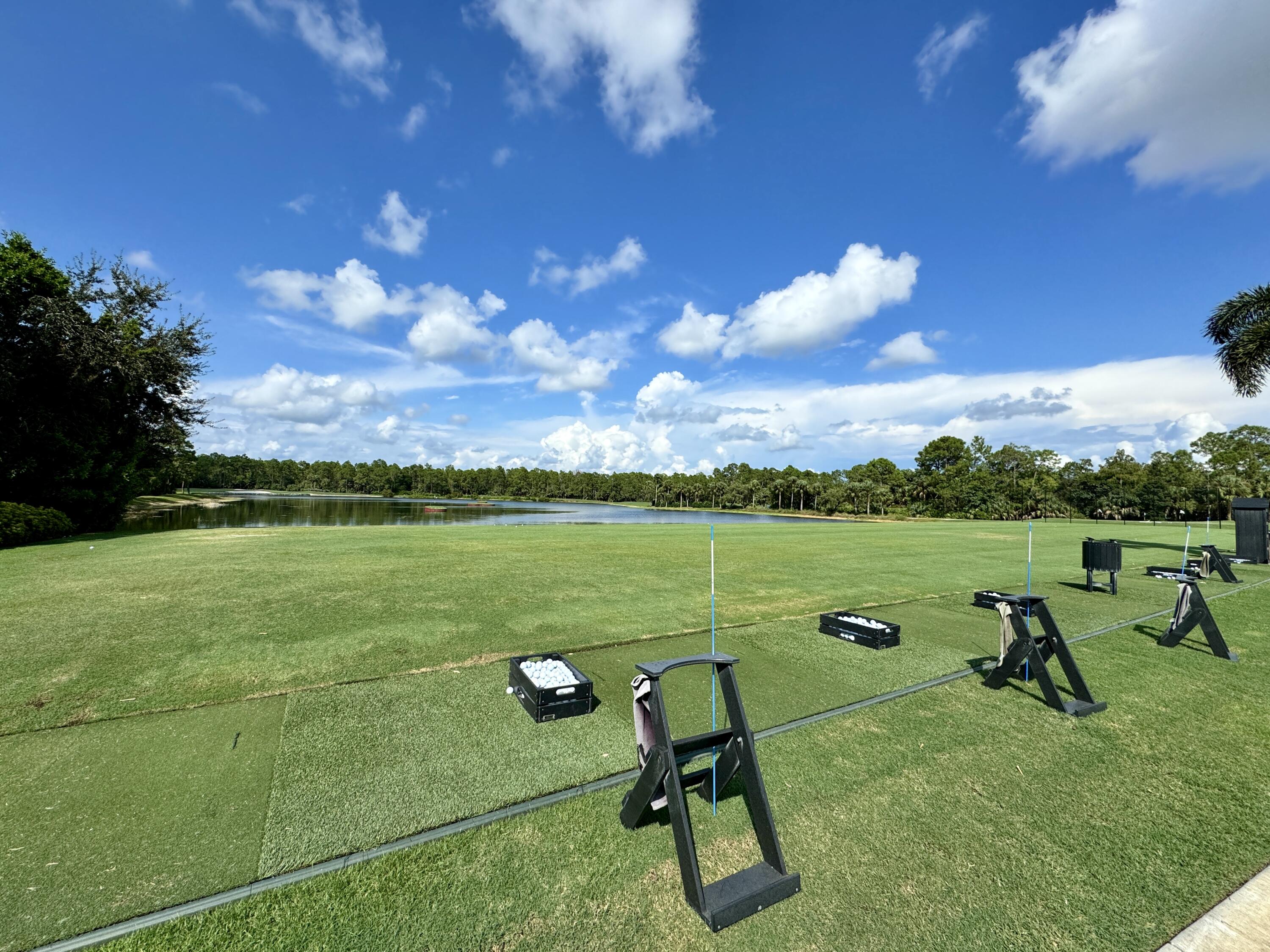3780 Sawgrass Way, Unit 3325 Naples, FL 34112 - Photo 43 of 49 a view of a lake with a yard