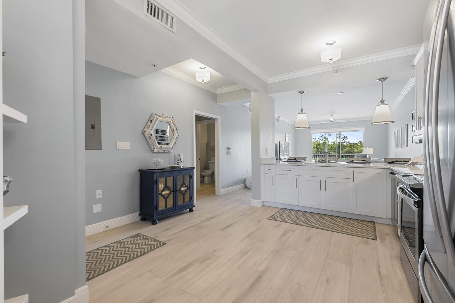 3780 Sawgrass Way, Unit 3325 Naples, FL 34112 - Photo 6 of 49 a large kitchen with a lot of counter space and stainless steel appliances