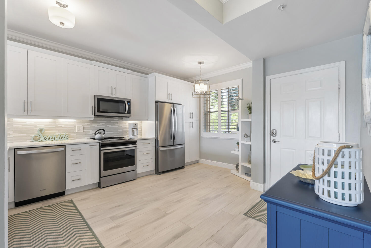 3780 Sawgrass Way, Unit 3325 Naples, FL 34112 - Photo 8 of 49 a kitchen with stainless steel appliances kitchen island granite countertop a refrigerator and a stove top oven