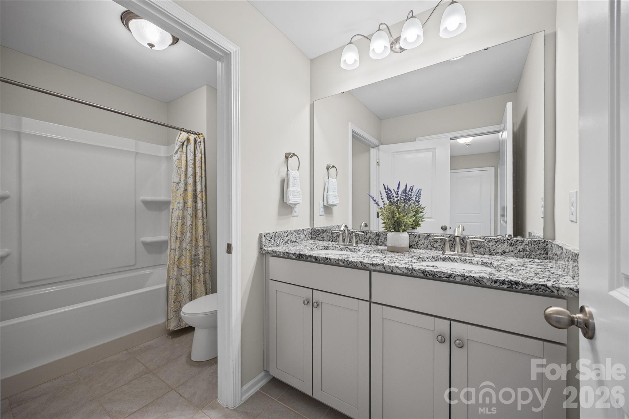 979 Pennington Drive Lancaster, SC 29720 - Photo 26 of 47 a bathroom with a granite countertop sink a toilet and shower