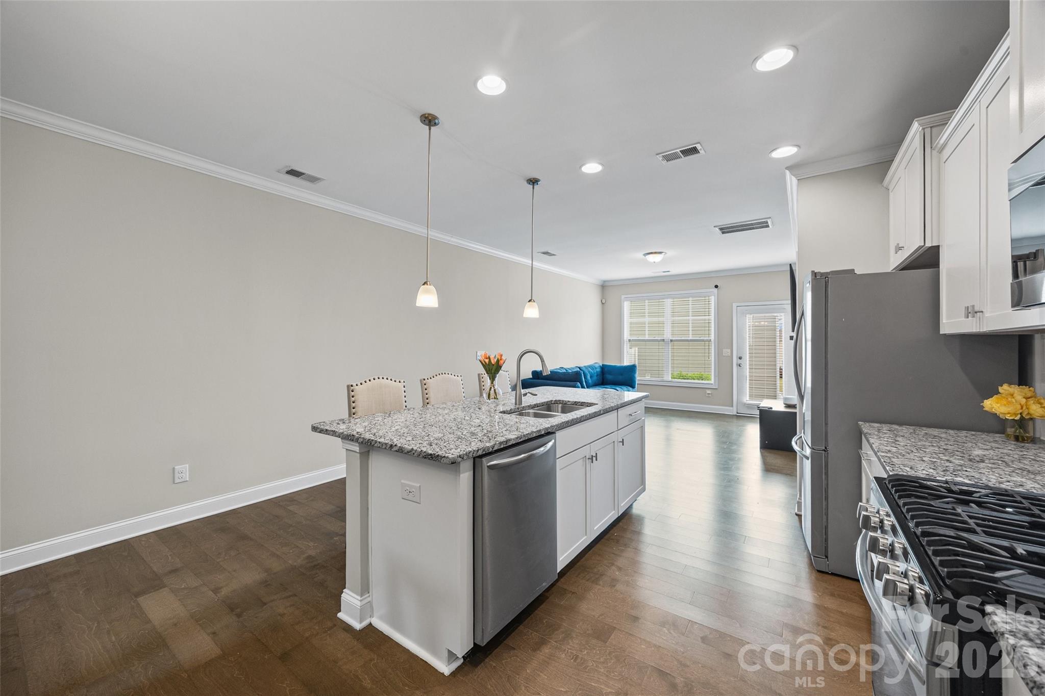 979 Pennington Drive Lancaster, SC 29720 - Photo 8 of 47 a kitchen with granite countertop a sink stove and refrigerator