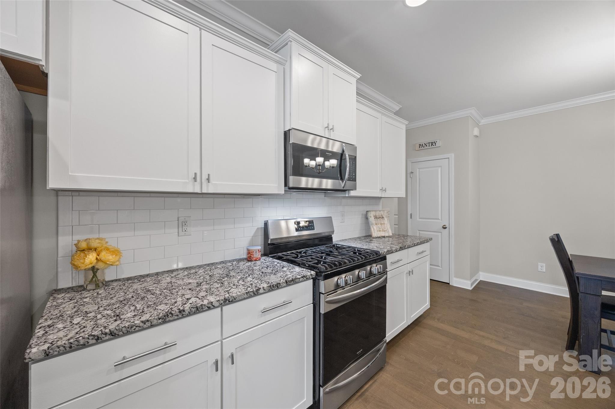 979 Pennington Drive Lancaster, SC 29720 - Photo 9 of 47 a kitchen with stainless steel appliances granite countertop a stove a sink and a microwave