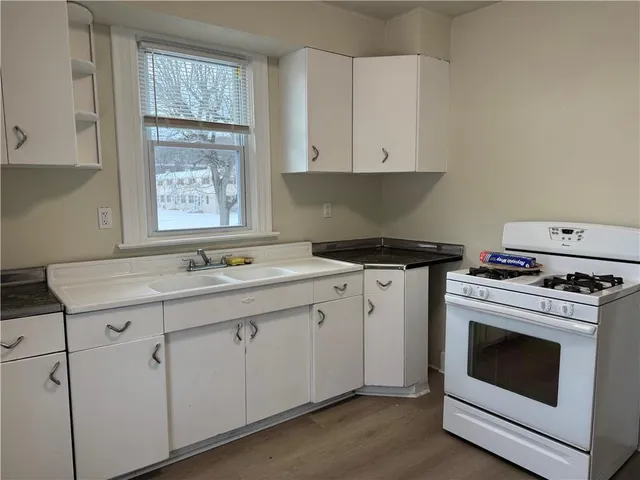 a kitchen with cabinets appliances and a sink