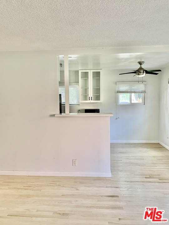 3040 Exposition Boulevard, Unit 1 Santa Monica, CA 90404 - Photo 4 of 15 a view of an empty room with wooden floor and a window