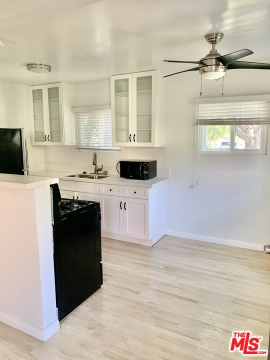 3040 Exposition Boulevard, Unit 1 Santa Monica, CA 90404 - Photo 5 of 15 a kitchen with a sink and a stove top oven