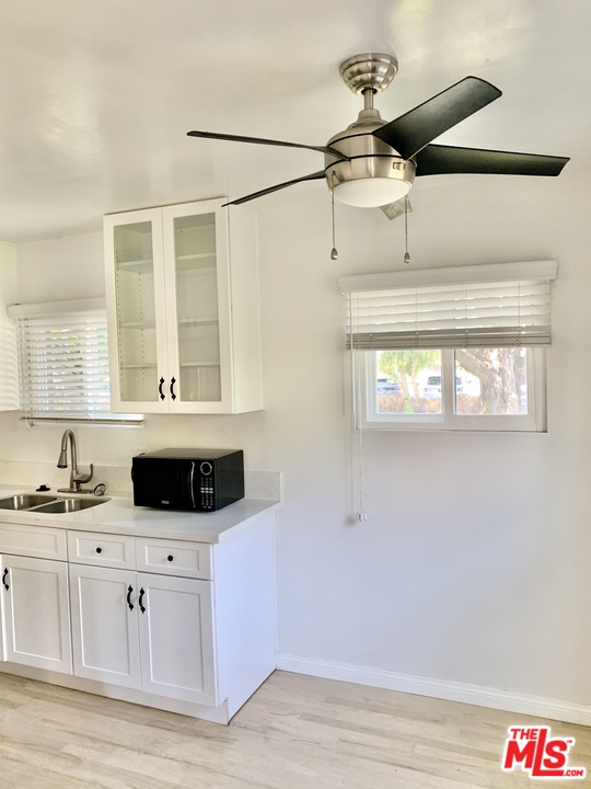 3040 Exposition Boulevard, Unit 1 Santa Monica, CA 90404 - Photo 6 of 15 a kitchen with a cabinets and chandelier