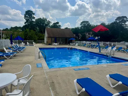 a view of a swimming pool with outdoor seating
