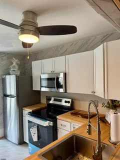 a kitchen with a stove a refrigerator and a sink