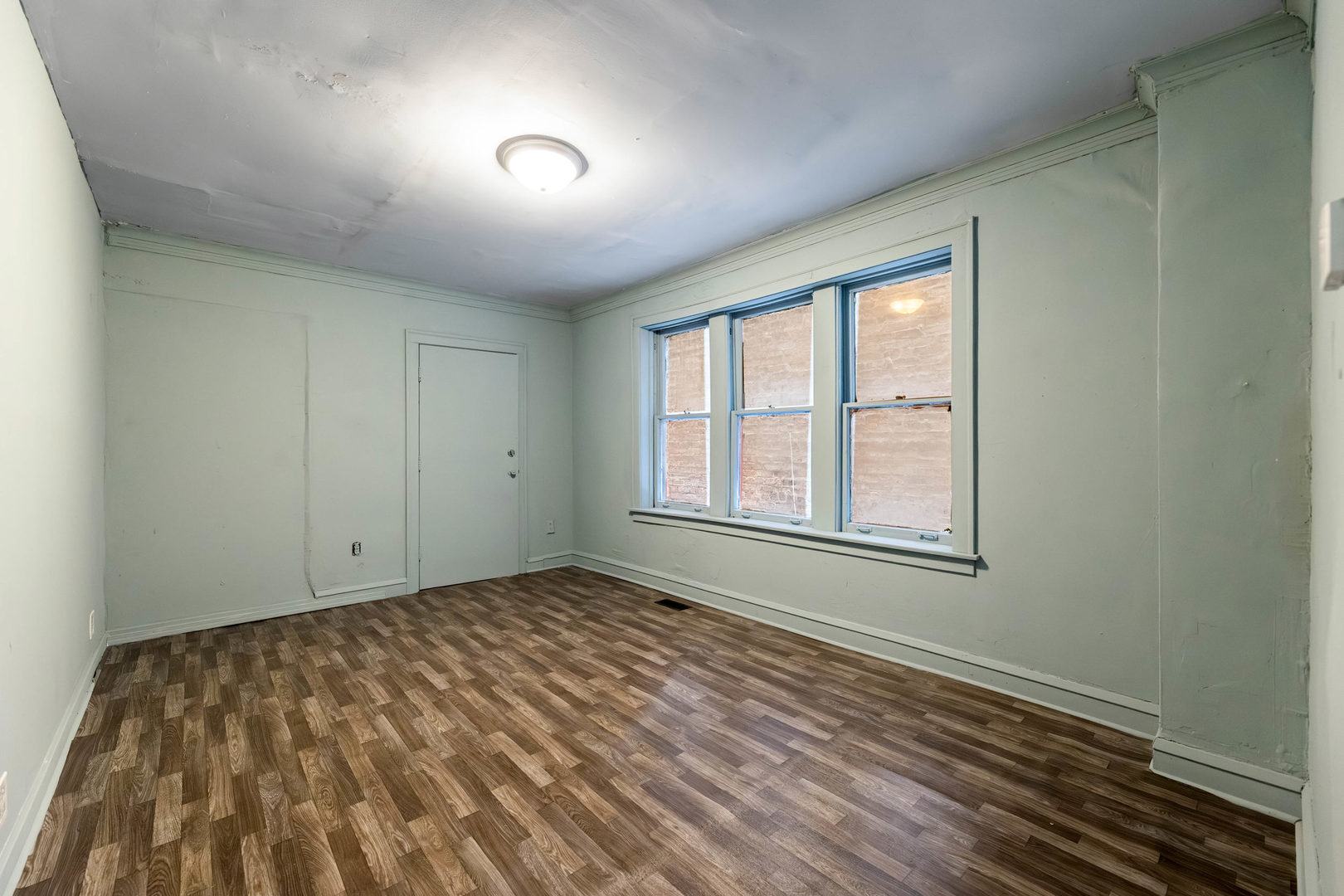 7316 South Racine Avenue Chicago, IL 60636 - Photo 5 of 15 a view of an empty room with a window