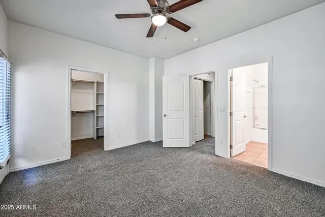 a view of empty room with ceiling fan