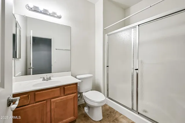 a bathroom with a toilet a sink and a mirror