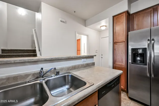 a kitchen with a refrigerator and a sink
